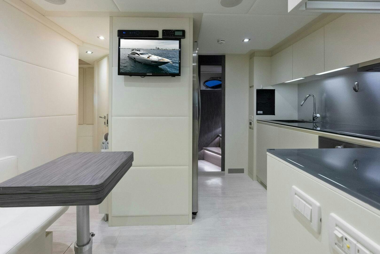 a room with a table and tv aboard PHOENIX RISING Yacht for Sale
