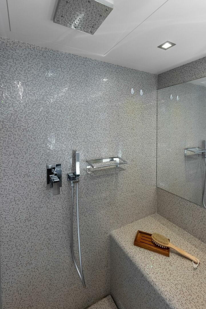 a bathroom with a shower and a sink aboard PHOENIX RISING Yacht for Sale