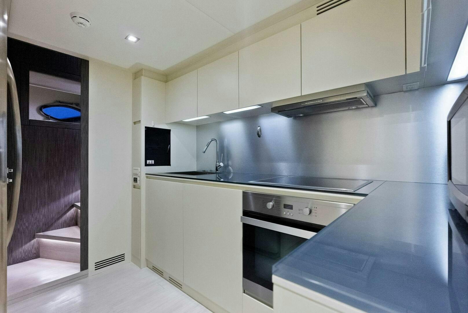 a kitchen with a stove and a sink aboard PHOENIX RISING Yacht for Sale