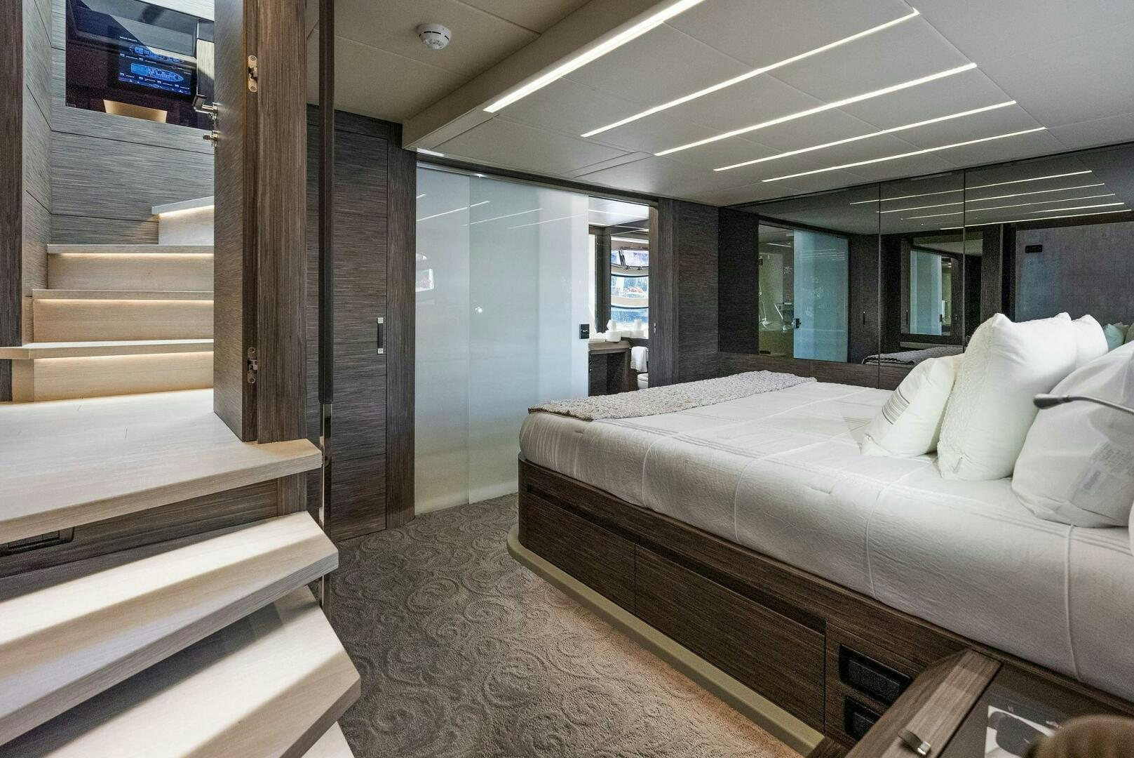 a room with a bed and a large mirror aboard PHOENIX RISING Yacht for Sale
