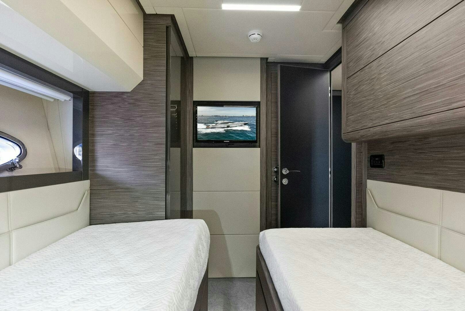 a room with a bed and a television aboard PHOENIX RISING Yacht for Sale