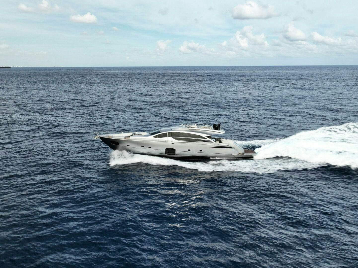 a white boat in the water aboard PHOENIX RISING Yacht for Sale