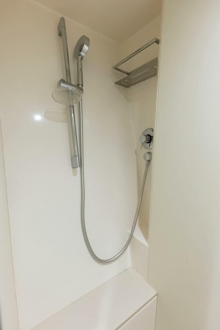 a shower head with a glass door aboard PHOENIX RISING Yacht for Sale