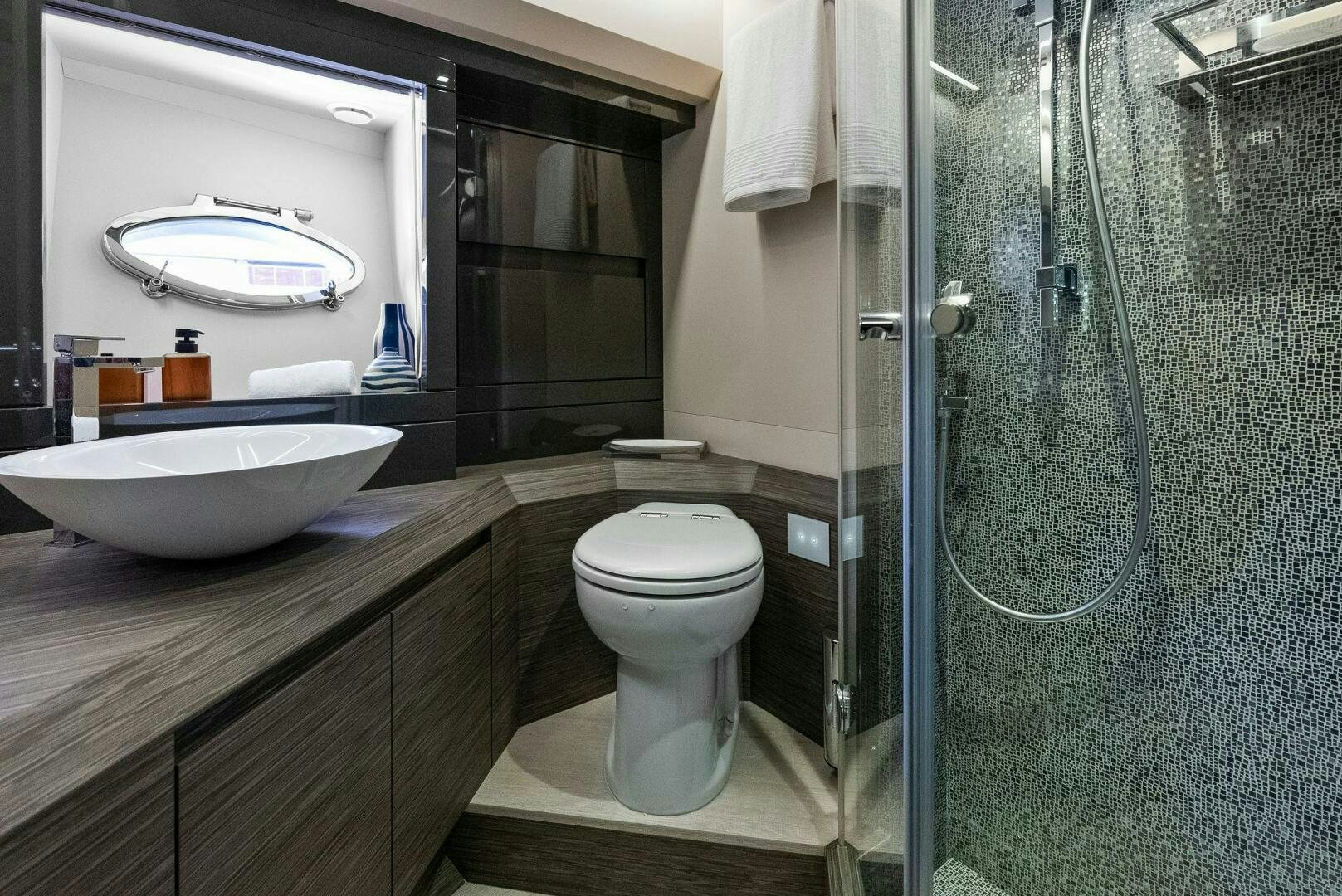 a bathroom with a glass shower aboard PHOENIX RISING Yacht for Sale