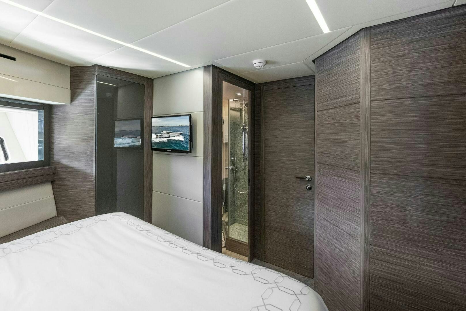a room with a bed and a television aboard PHOENIX RISING Yacht for Sale
