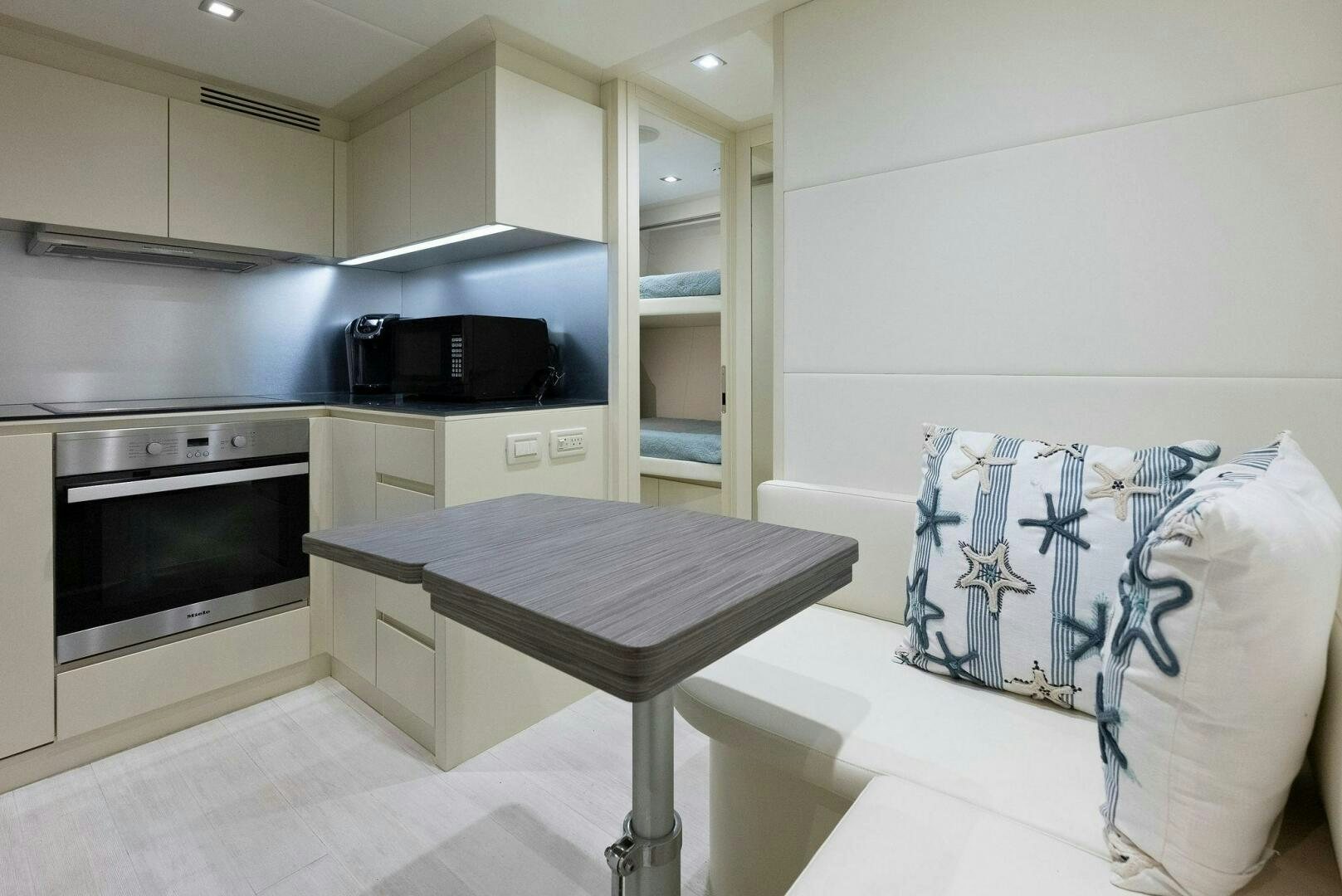a kitchen with a table and a microwave aboard PHOENIX RISING Yacht for Sale