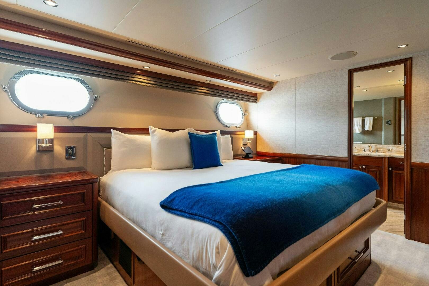 a bed with blue and white pillows aboard ANTARES Yacht for Sale