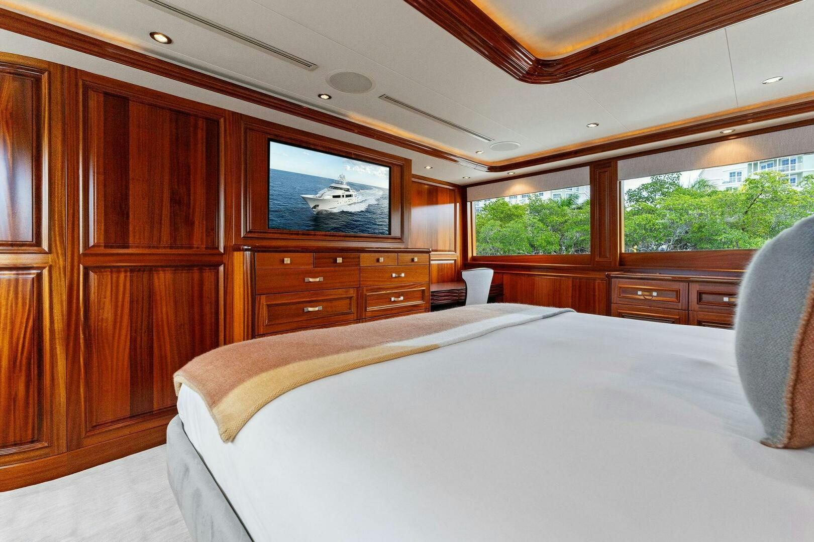 a bedroom with a bed and a television aboard ANTARES Yacht for Sale