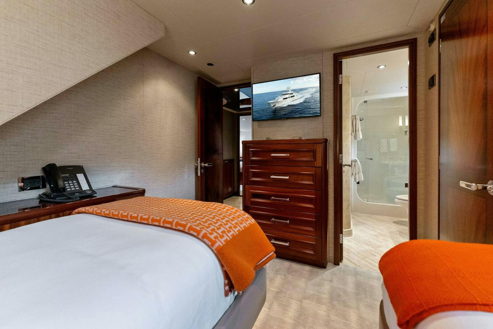 a hotel room with a bed and a television aboard ANTARES Yacht for Sale