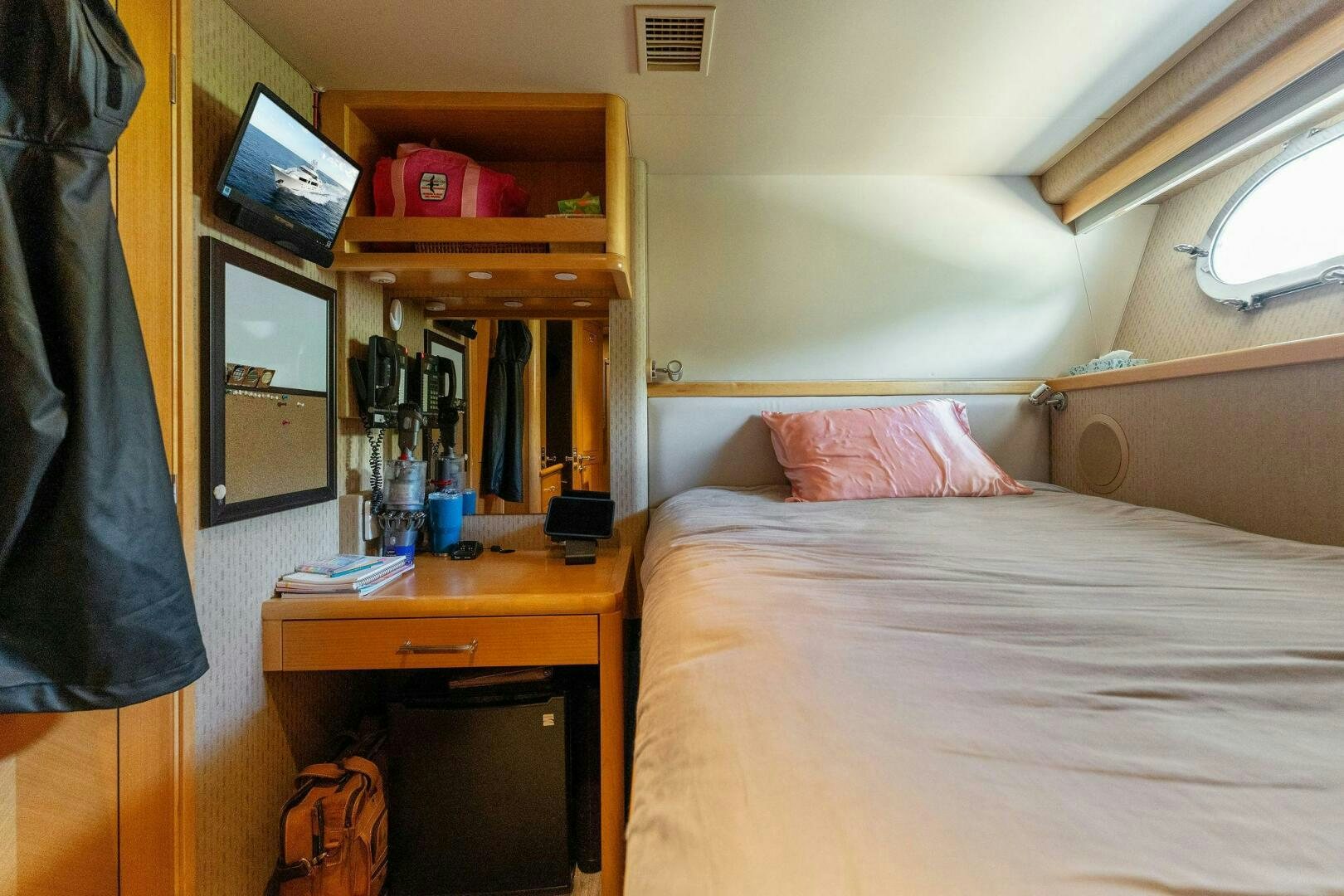 a bedroom with a bed and a desk aboard ANTARES Yacht for Sale