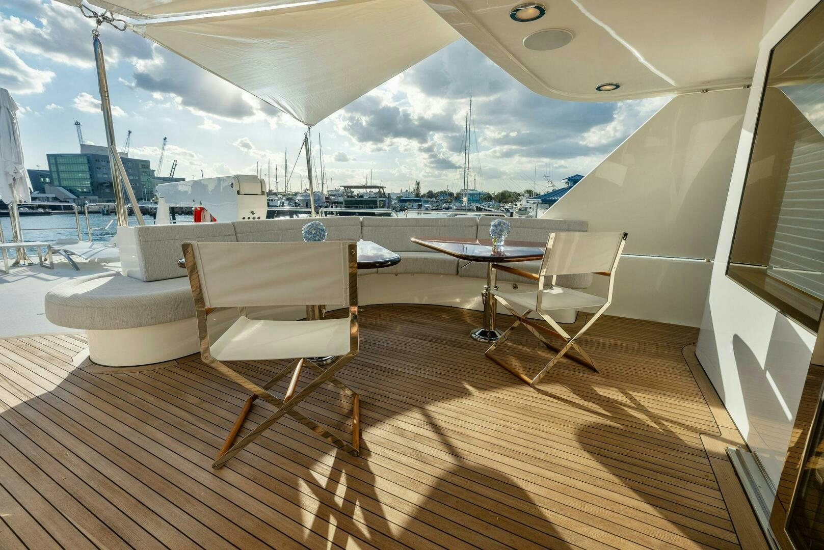 a deck with chairs and tables aboard ANTARES Yacht for Sale