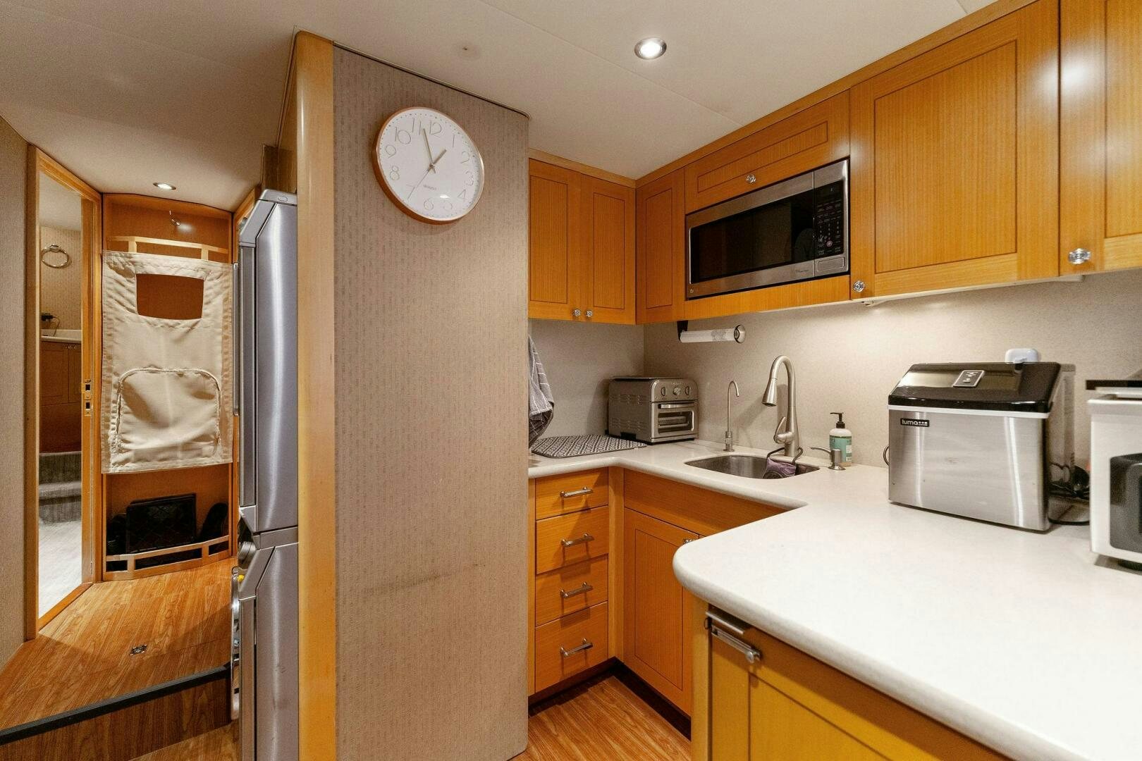 a kitchen with a refrigerator and microwave aboard ANTARES Yacht for Sale