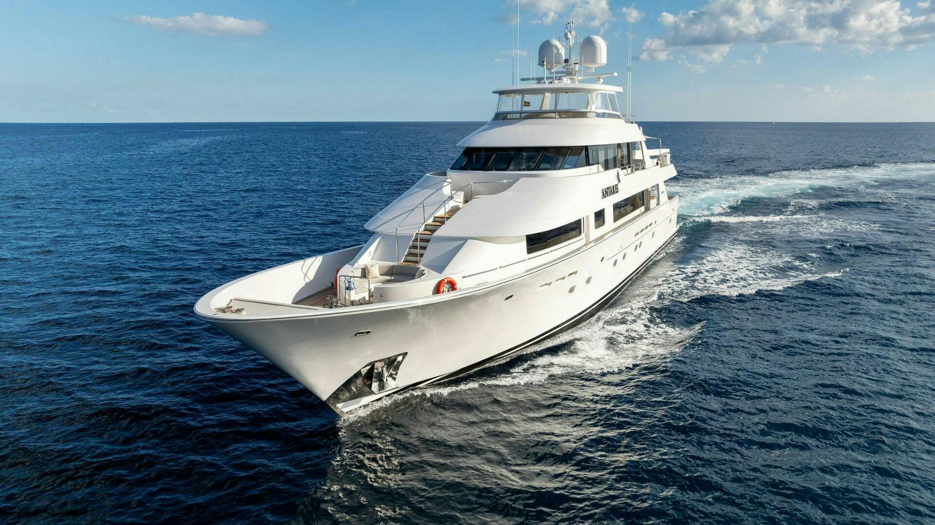 a white yacht in the water aboard ANTARES Yacht for Sale