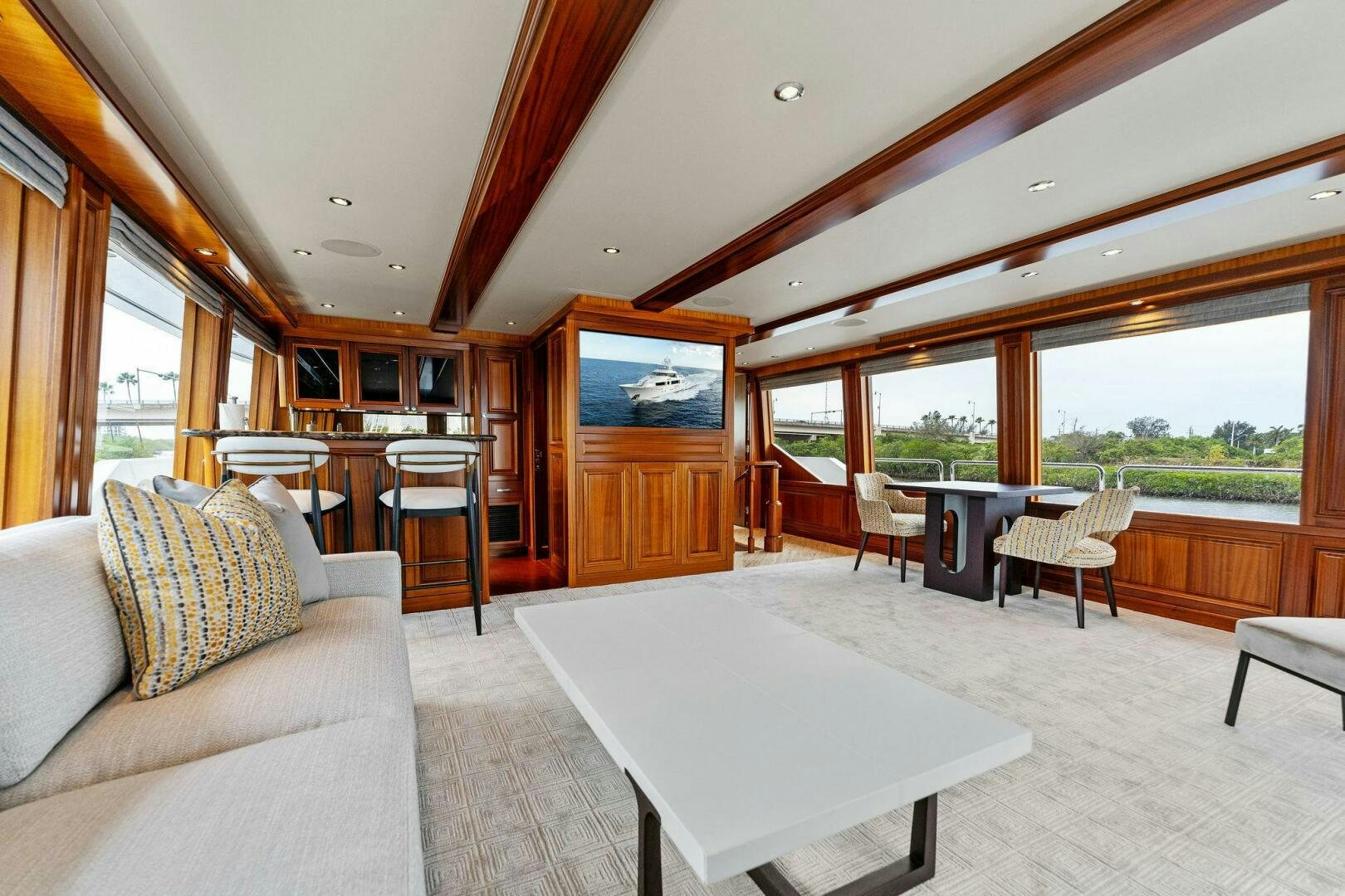 a living room with a table and couches aboard ANTARES Yacht for Sale