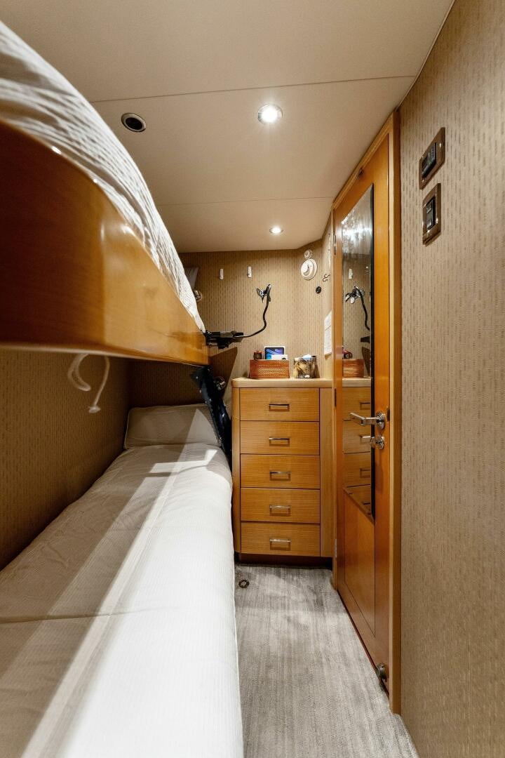 a bedroom with a bed and a lamp aboard ANTARES Yacht for Sale