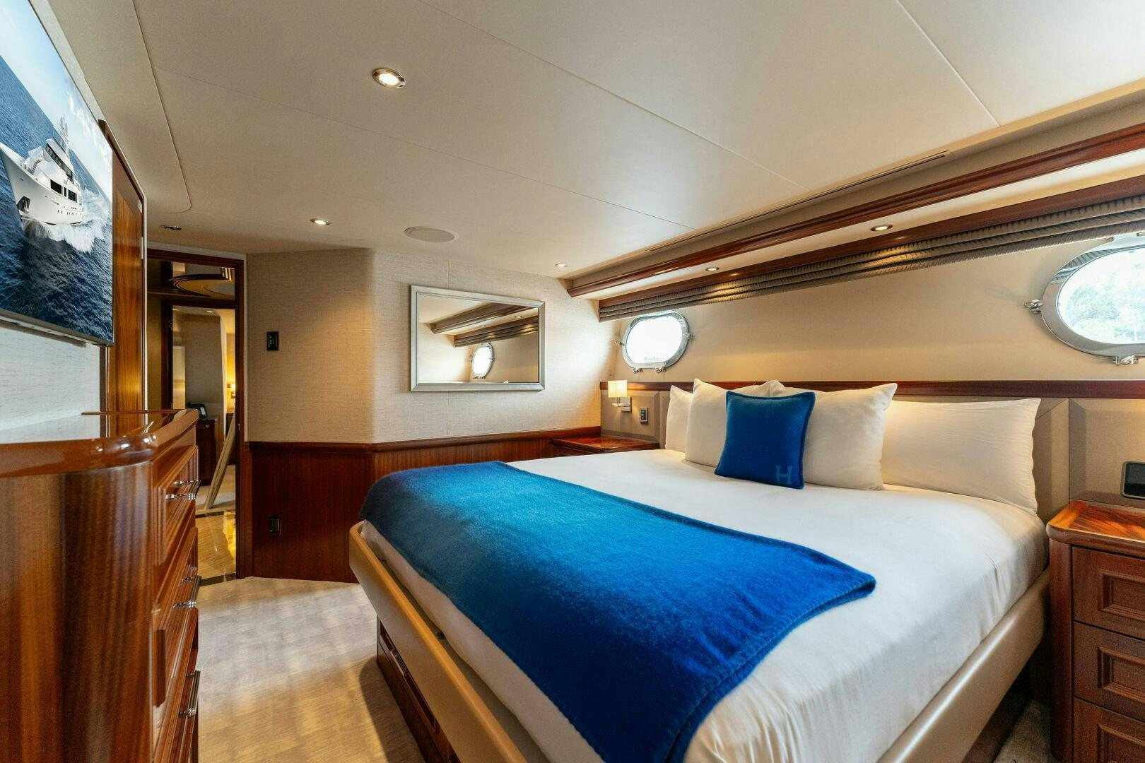 a bed with blue sheets aboard ANTARES Yacht for Sale