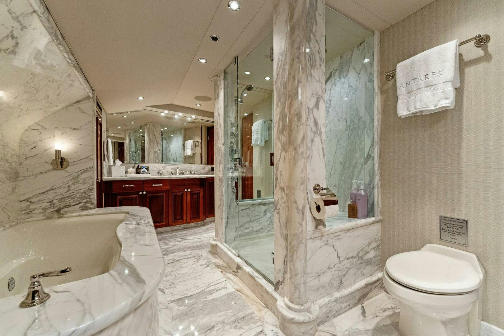 a bathroom with a glass shower aboard ANTARES Yacht for Sale