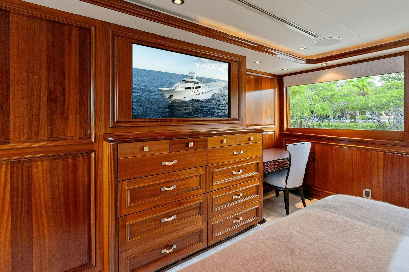 a bedroom with a large television aboard ANTARES Yacht for Sale