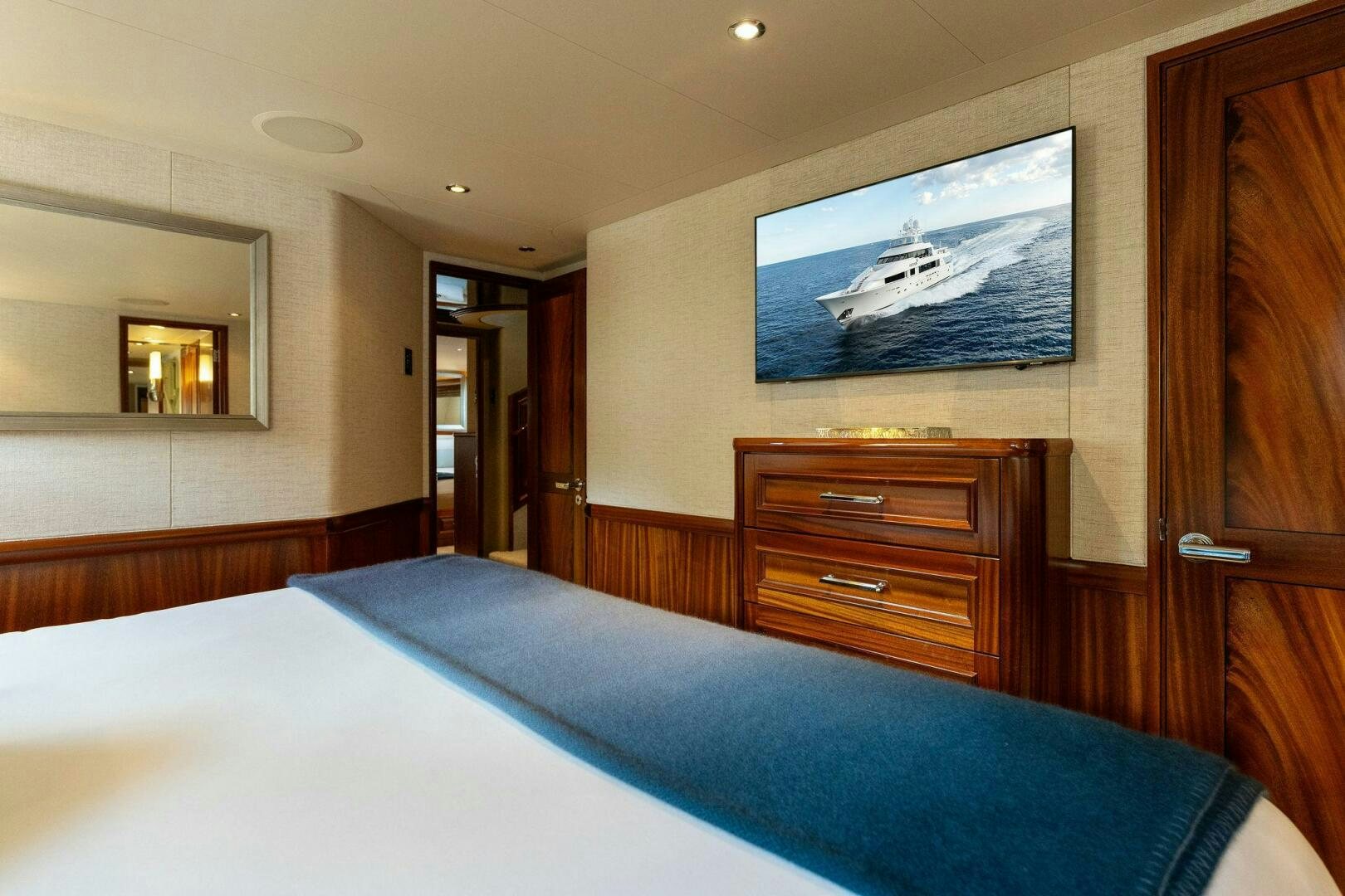 a bedroom with a television on the wall aboard ANTARES Yacht for Sale