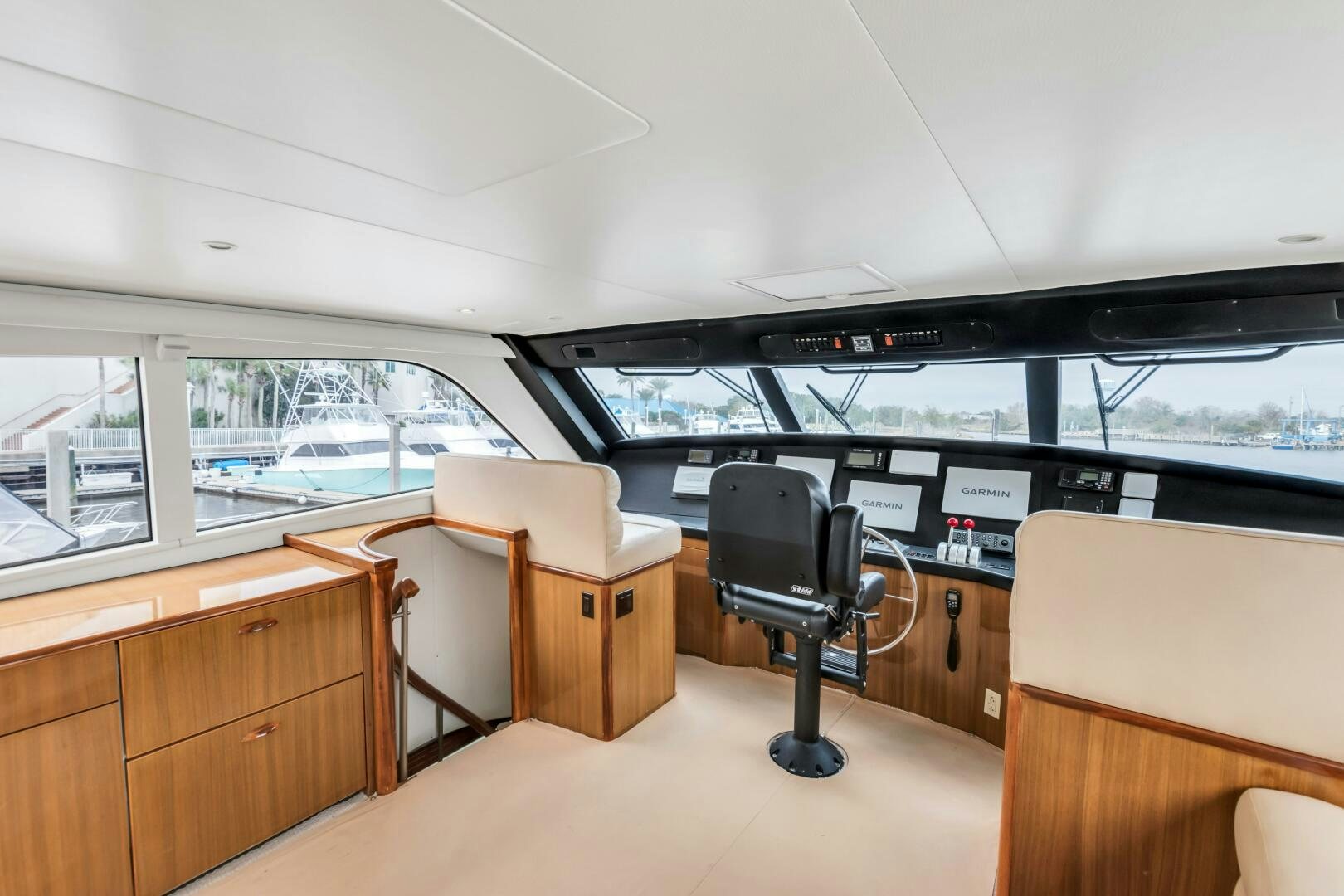 a room with a chair and a table and a large window aboard BERRY BLESSED Yacht for Sale