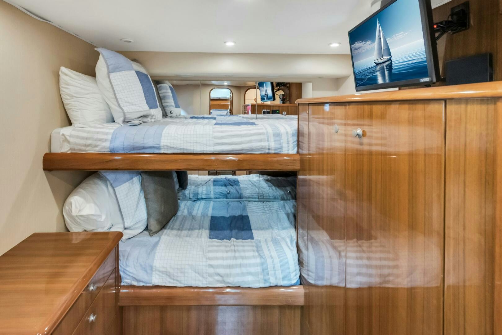 a bed with a television on the wall aboard BERRY BLESSED Yacht for Sale