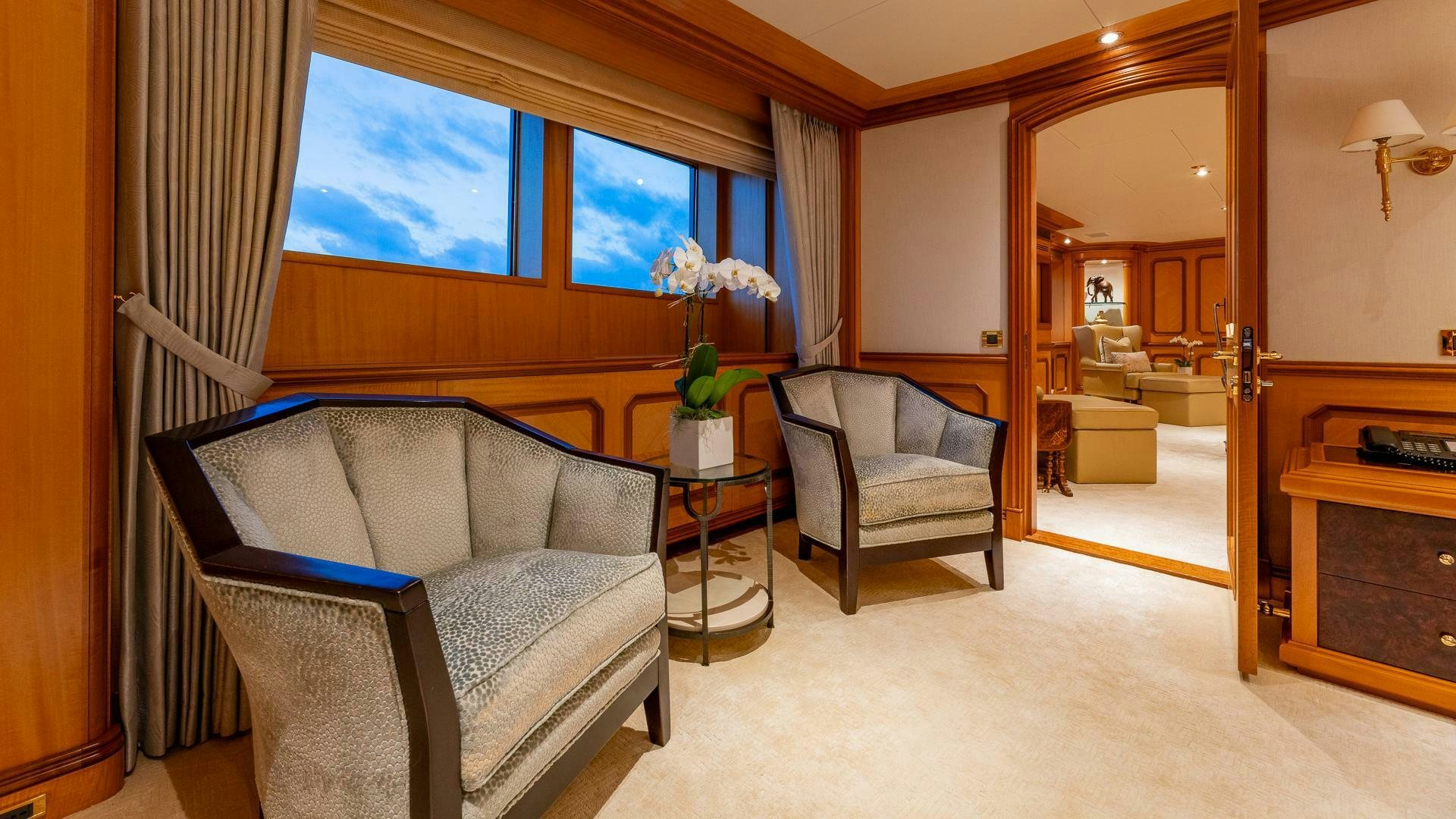 a living room with a couch and a table aboard AMANTI Yacht for Sale