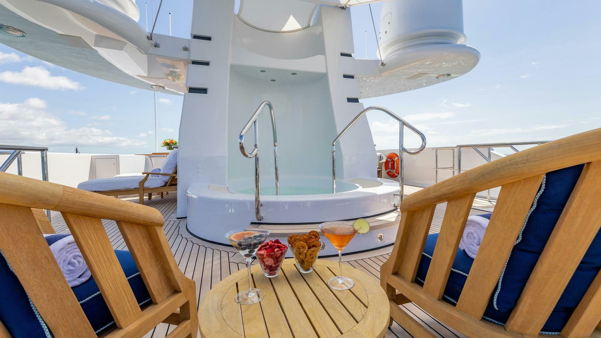 a table with wine glasses and food on it aboard AMANTI Yacht for Sale