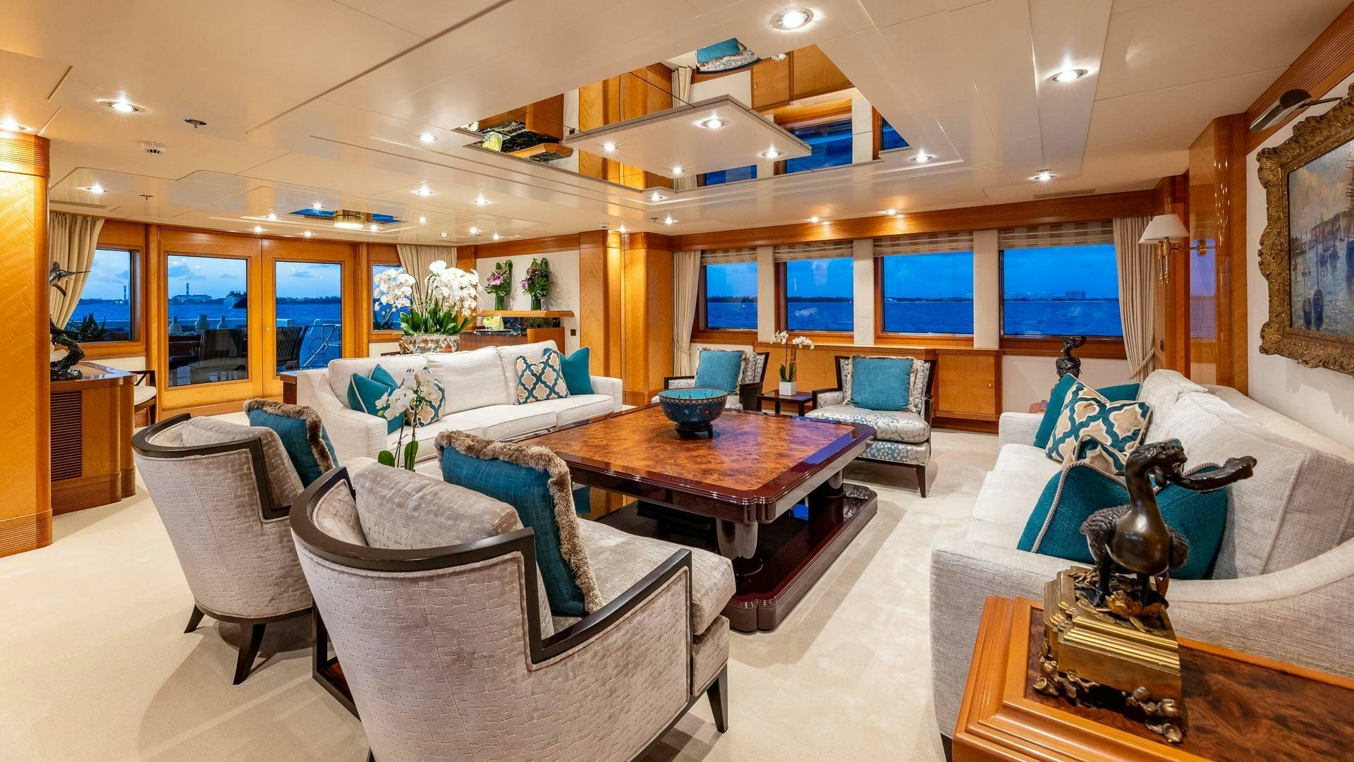 a living room with a table and chairs aboard AMANTI Yacht for Sale