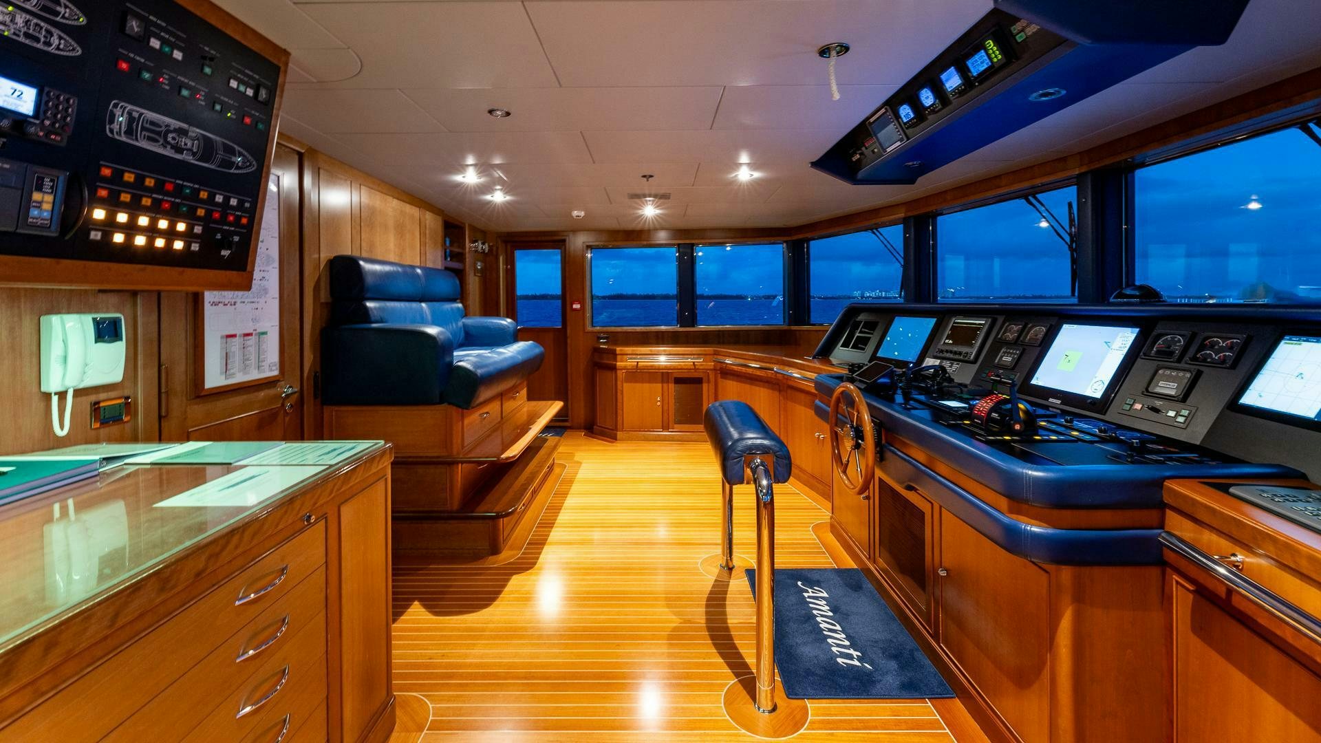 a room with a desk and chairs aboard AMANTI Yacht for Sale