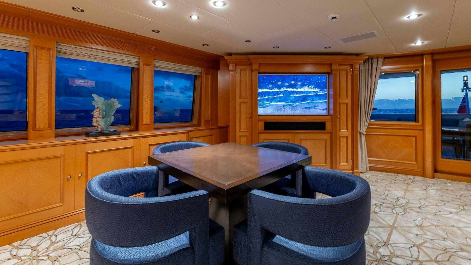 a room with a table and chairs aboard AMANTI Yacht for Sale