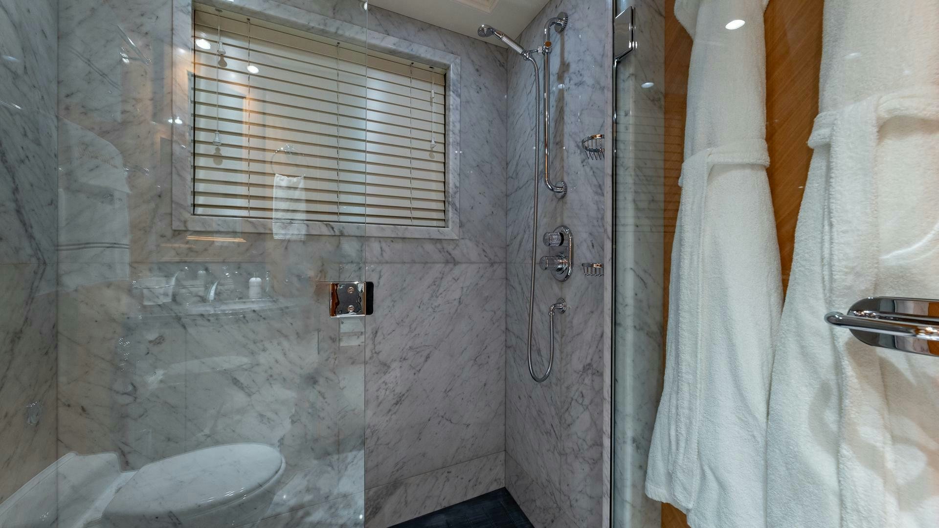a bathroom with a shower curtain aboard AMANTI Yacht for Sale