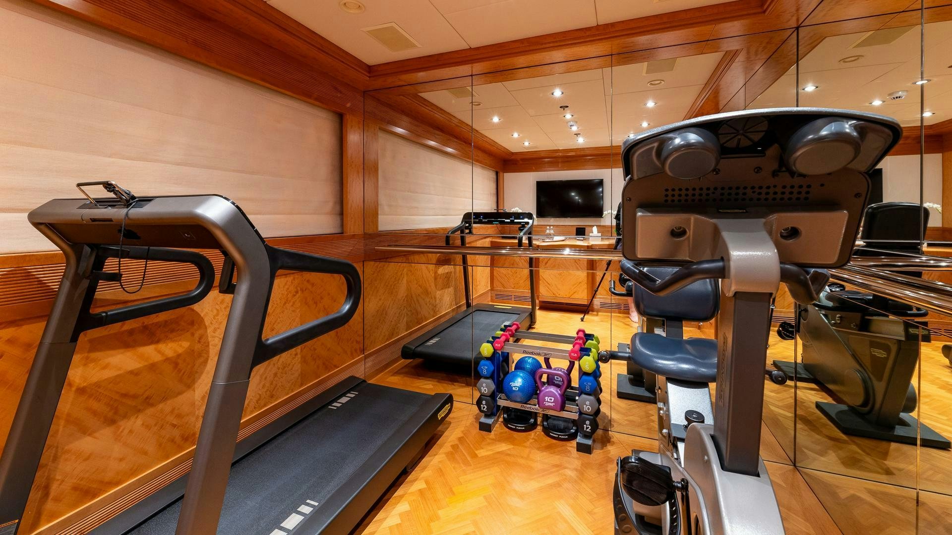 a gym with exercise equipment aboard AMANTI Yacht for Sale