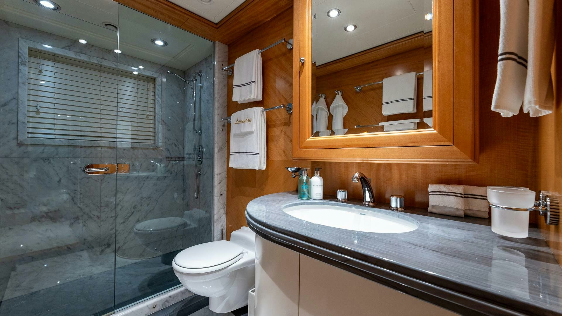 a bathroom with a glass shower aboard AMANTI Yacht for Sale