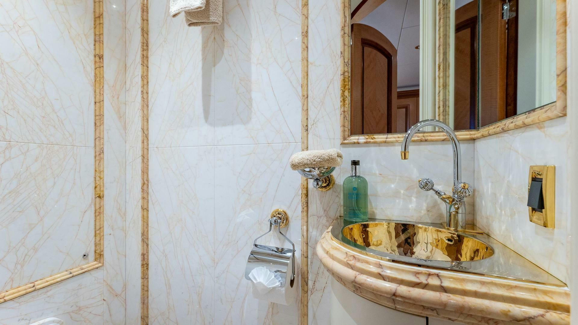 a bathroom with a sink and a mirror aboard AMANTI Yacht for Sale