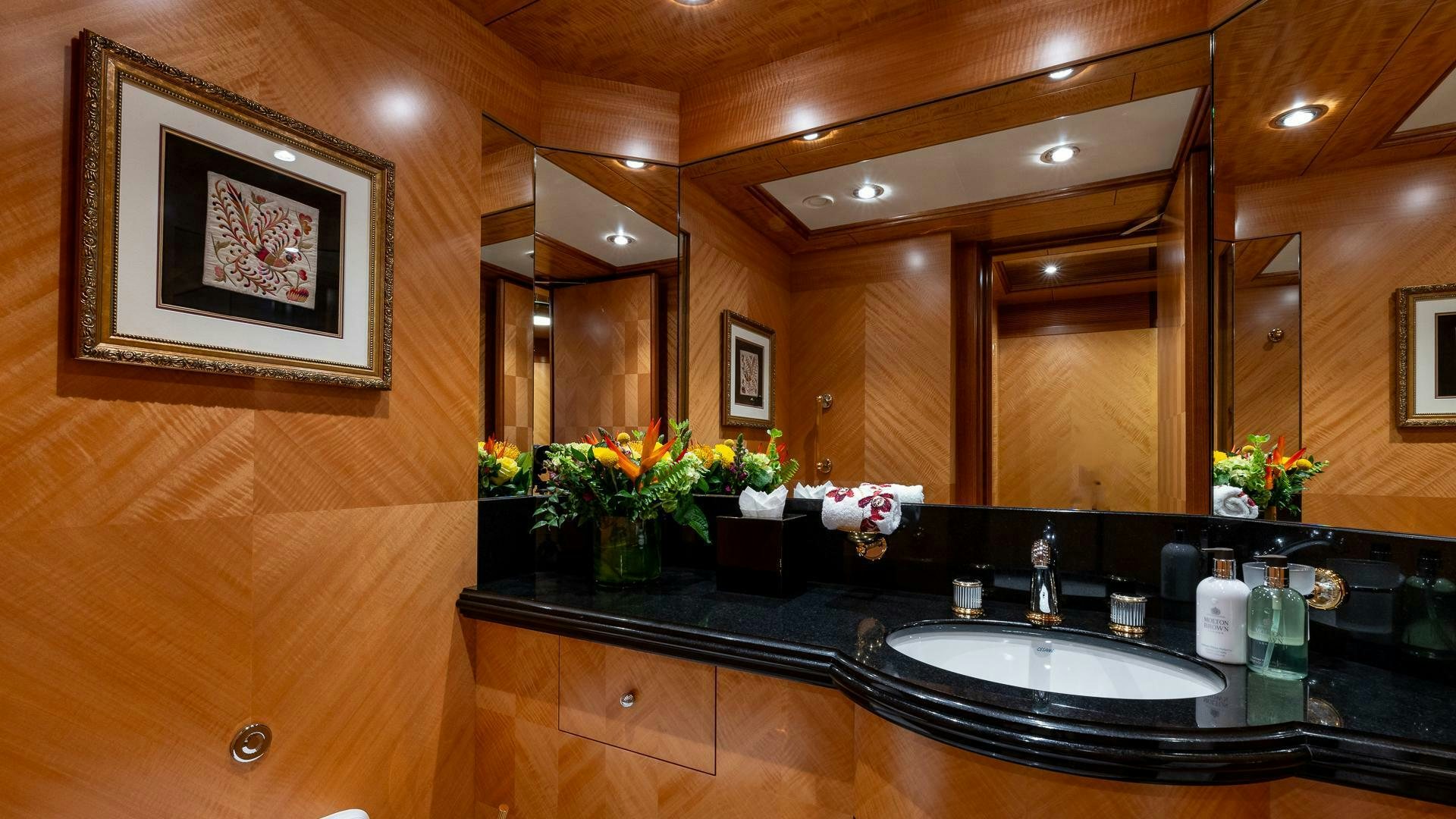 a bathroom with a countertop sink and mirror aboard AMANTI Yacht for Sale