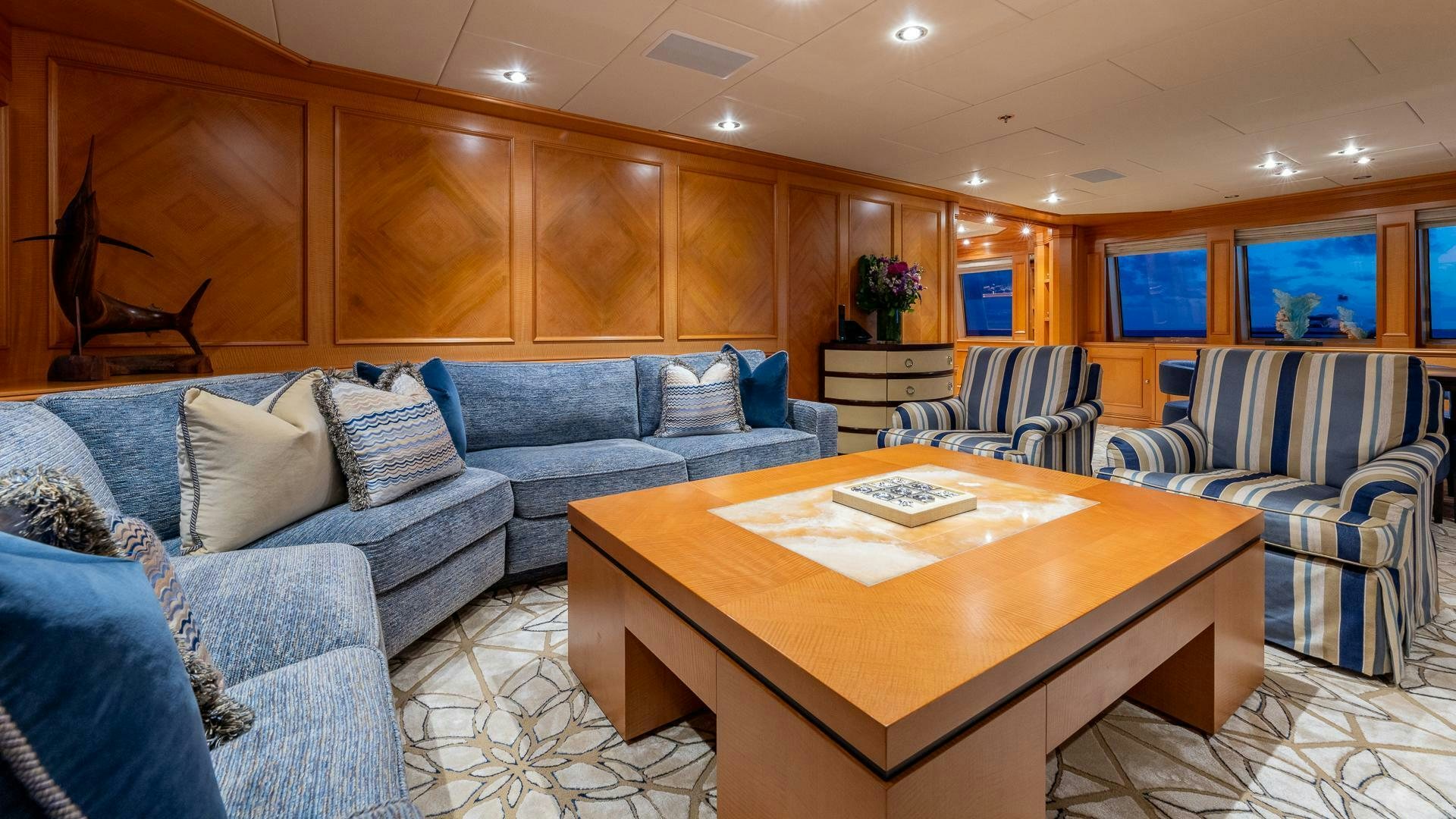 a living room with a couch and a table aboard AMANTI Yacht for Sale