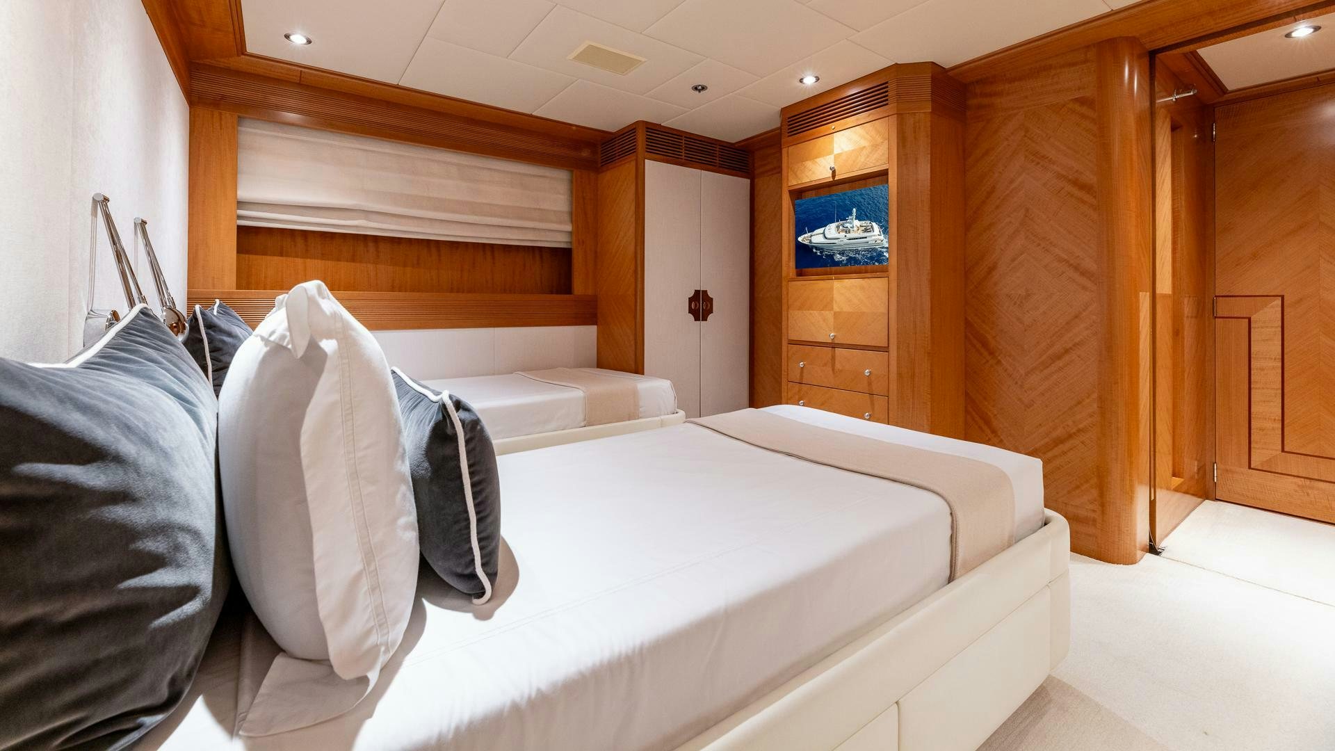 a room with a bed and a desk aboard AMANTI Yacht for Sale