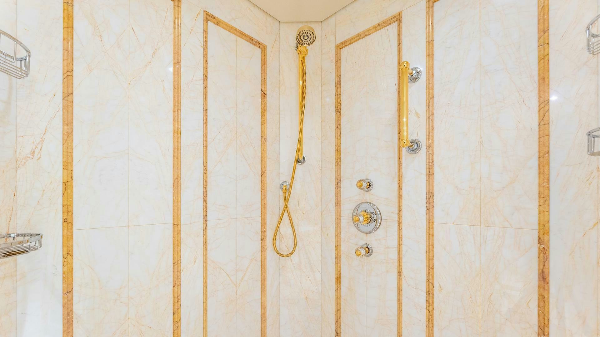 a white wall with gold chains aboard AMANTI Yacht for Sale