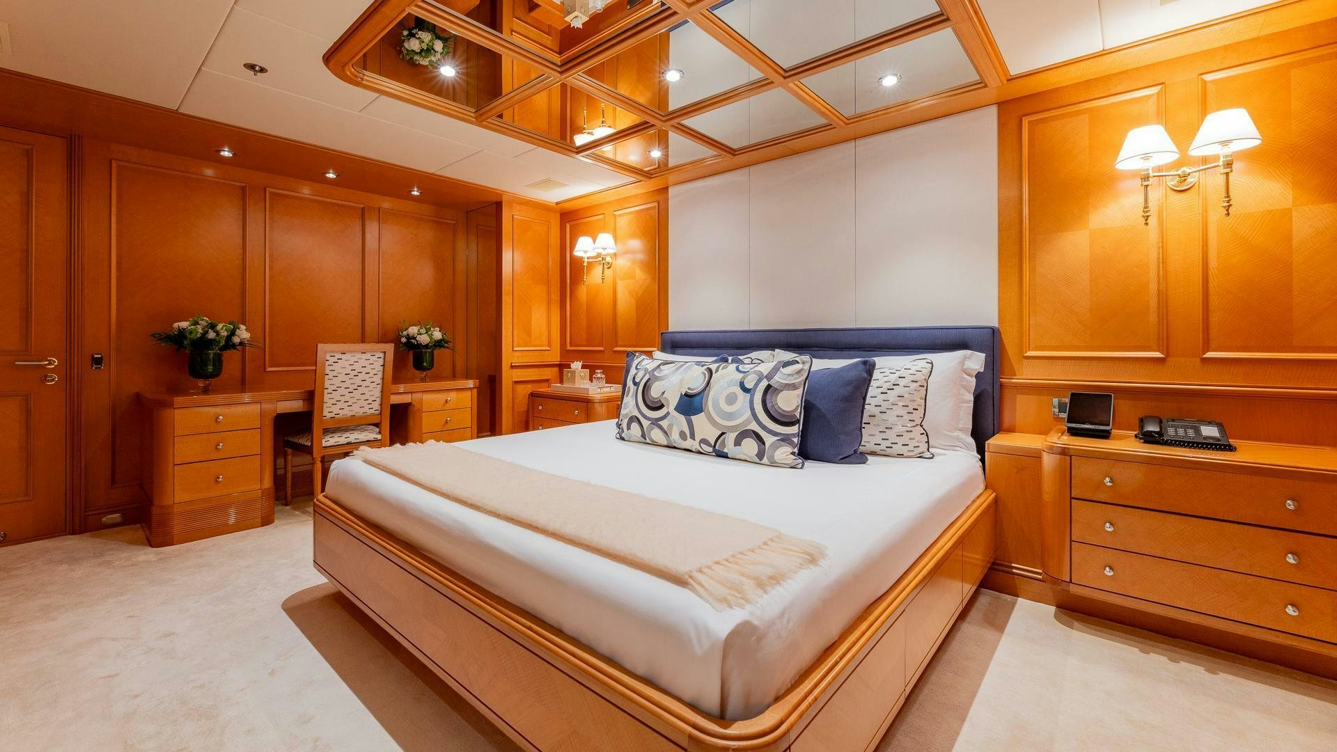 a bedroom with a bed and a desk aboard AMANTI Yacht for Sale