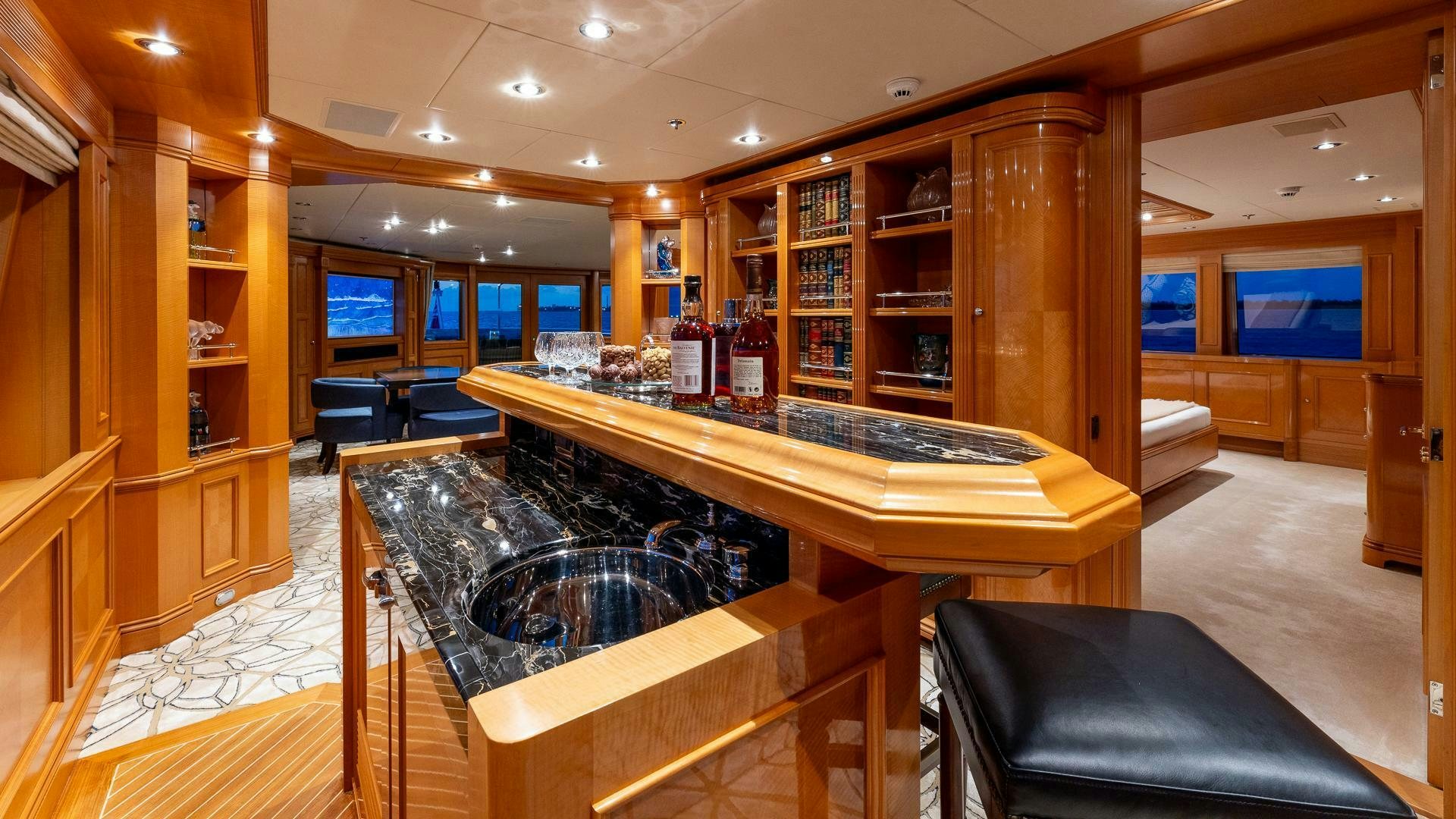 a room with a table and chairs aboard AMANTI Yacht for Sale