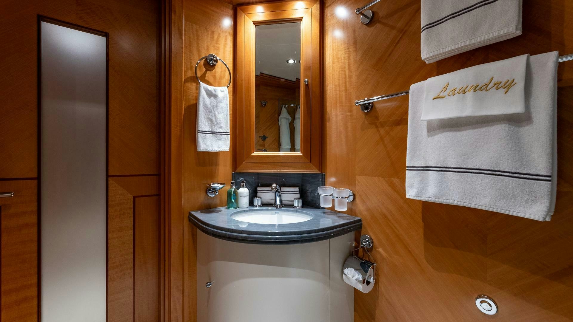a bathroom with a sink and a mirror aboard AMANTI Yacht for Sale