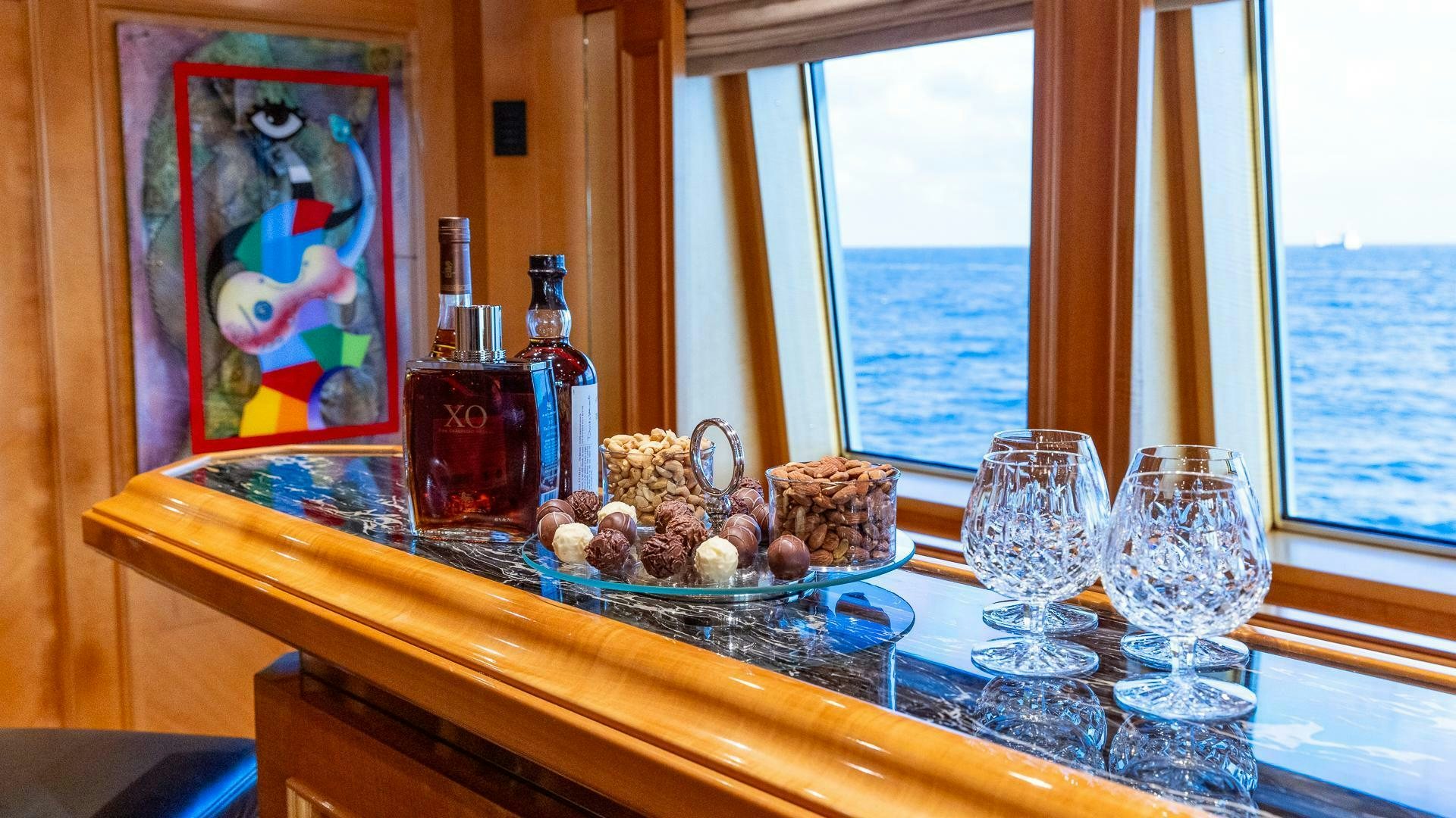 a table with food and drinks on it aboard AMANTI Yacht for Sale