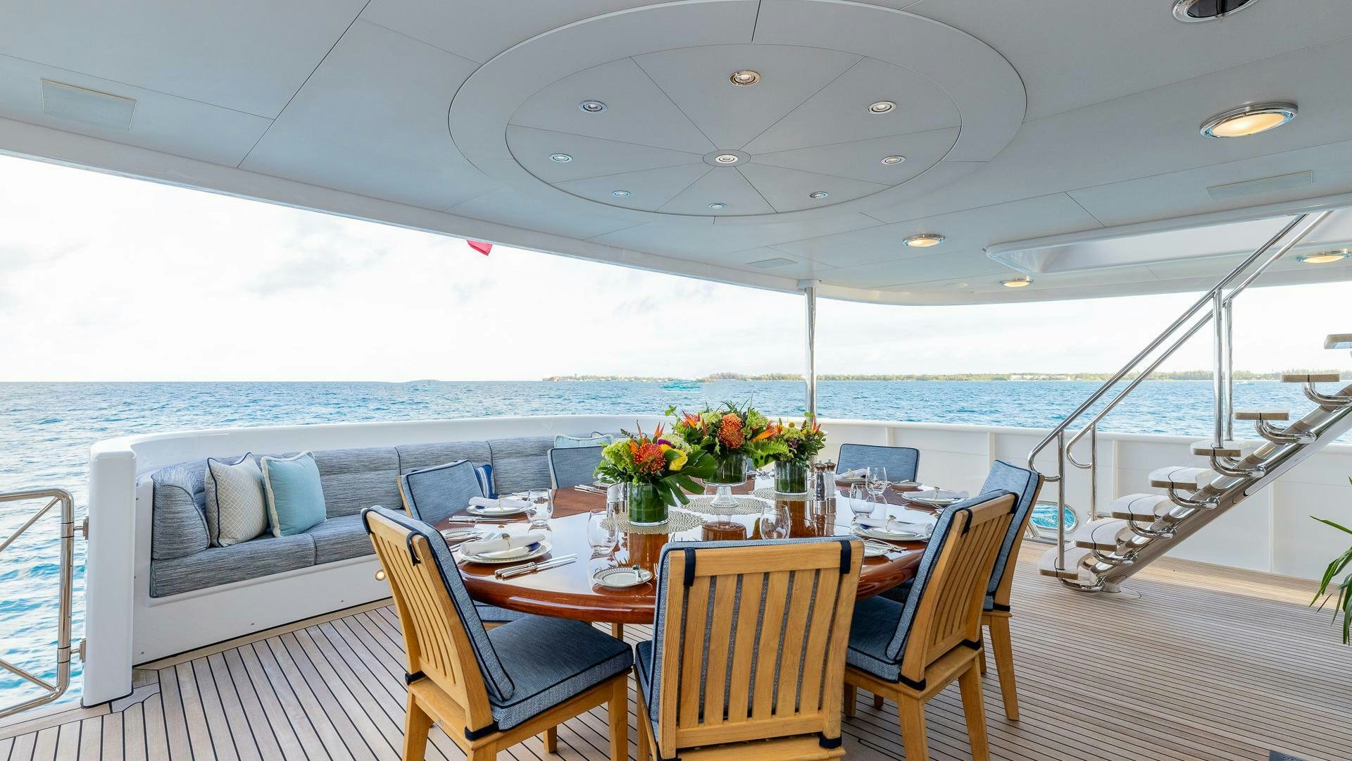 a large dining table on a deck aboard AMANTI Yacht for Sale
