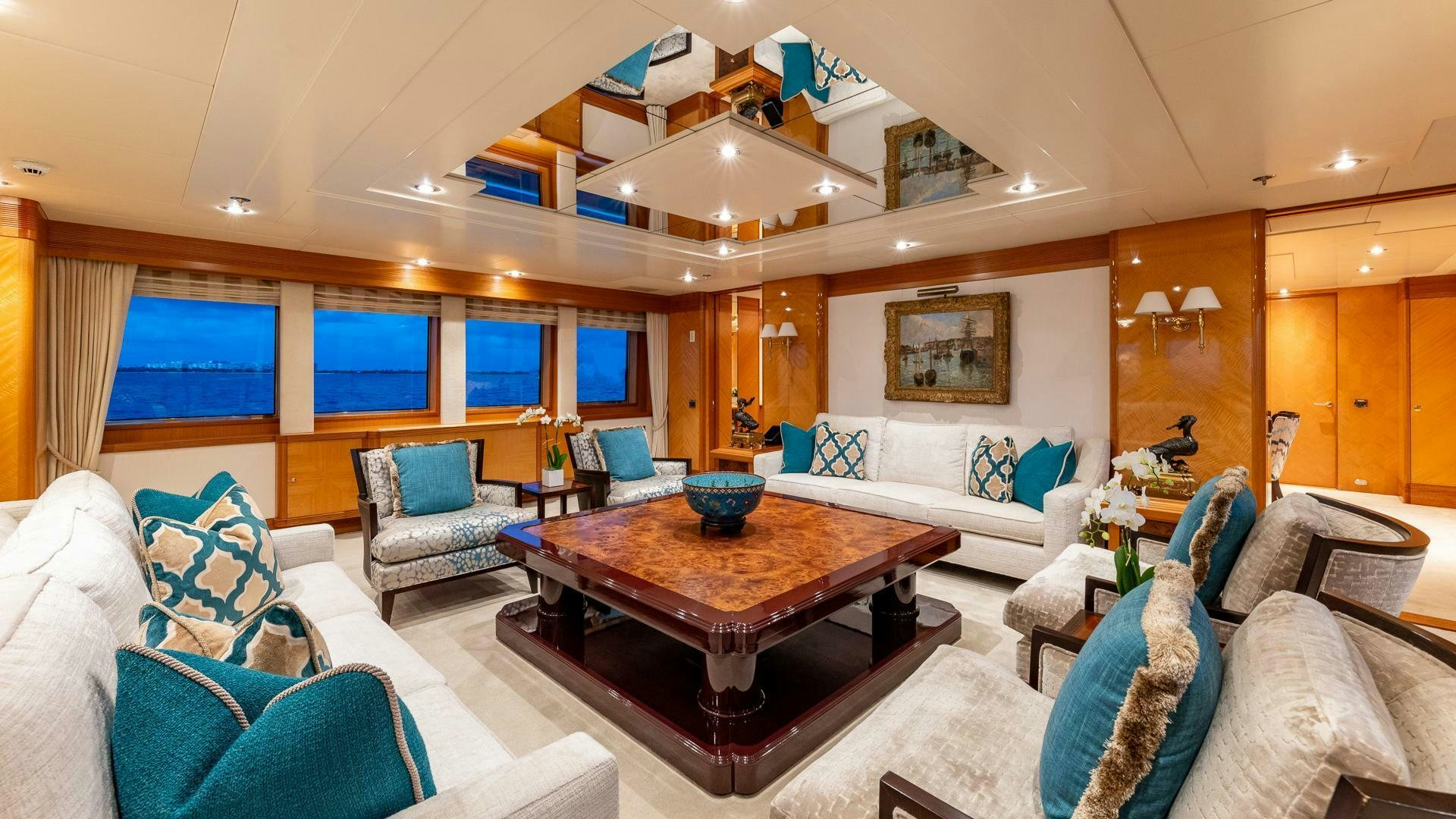 a living room with a table and chairs aboard AMANTI Yacht for Sale