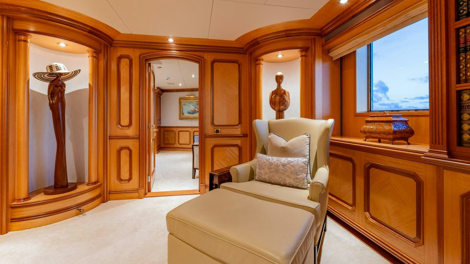 a room with a couch and a mirror aboard AMANTI Yacht for Sale