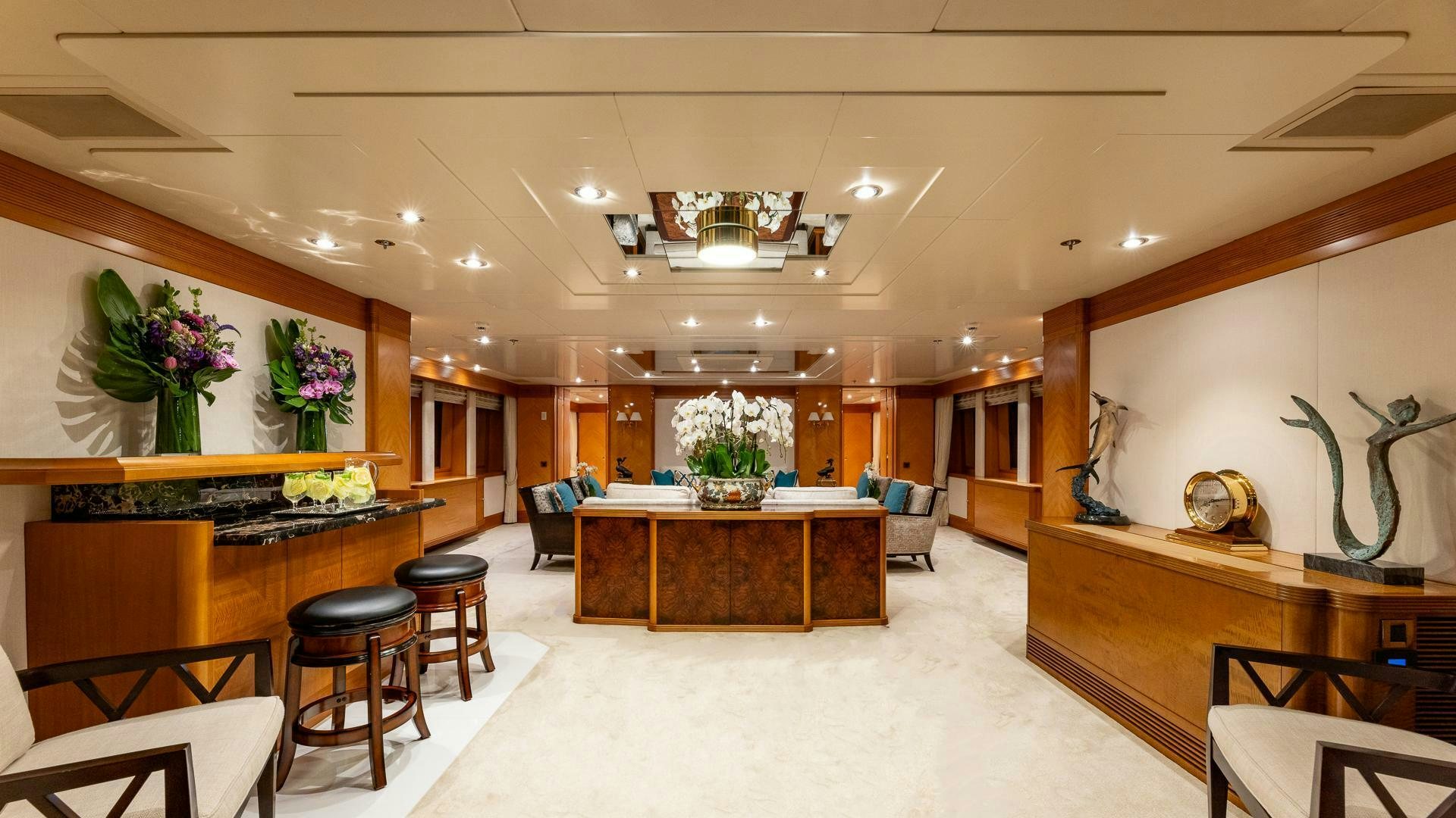 a room with a table chairs and plants aboard AMANTI Yacht for Sale