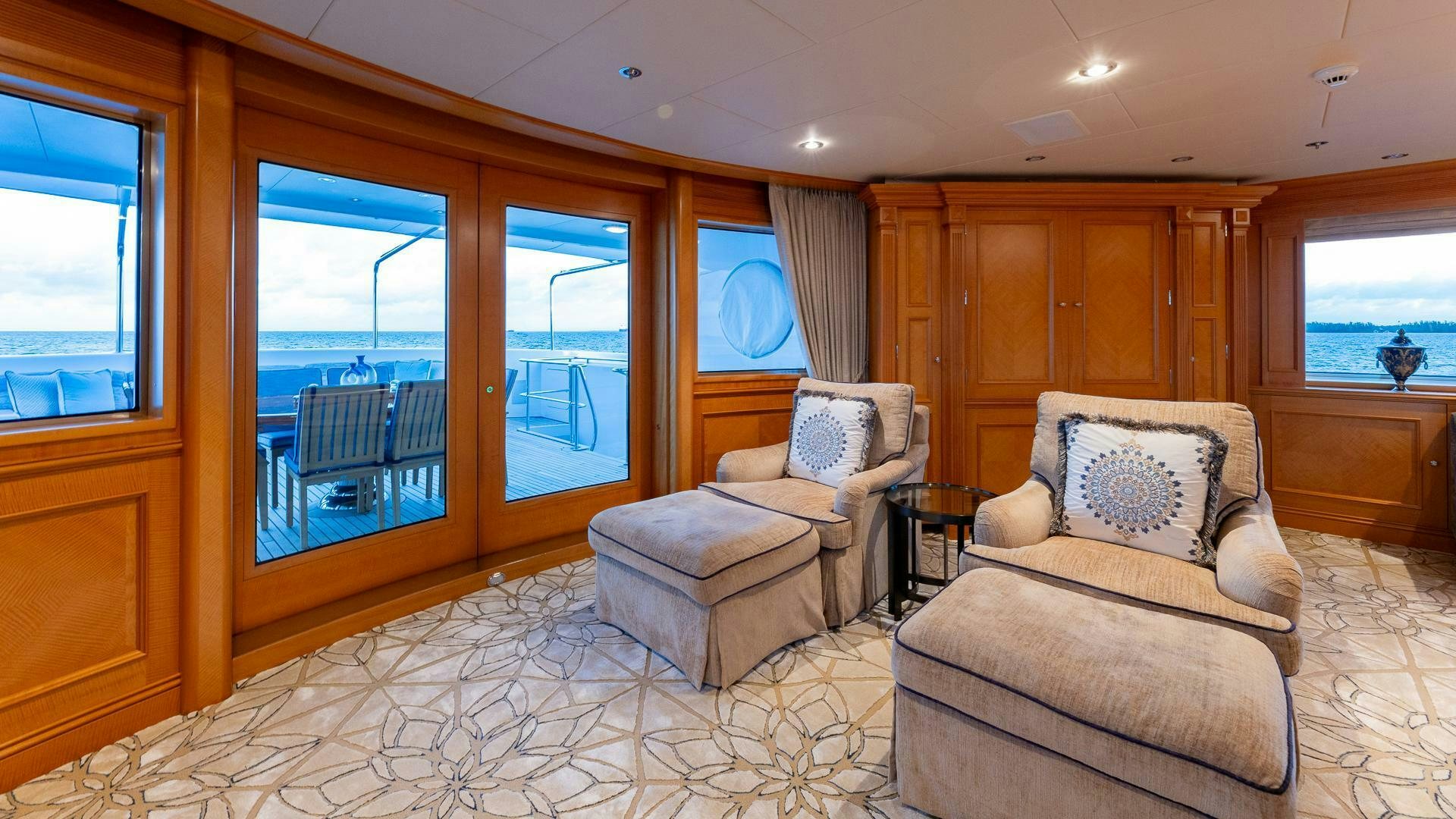a living room with a couch and a chair aboard AMANTI Yacht for Sale