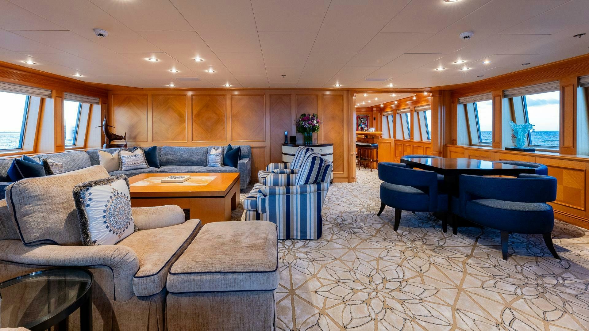 a living room with a table and chairs aboard AMANTI Yacht for Sale