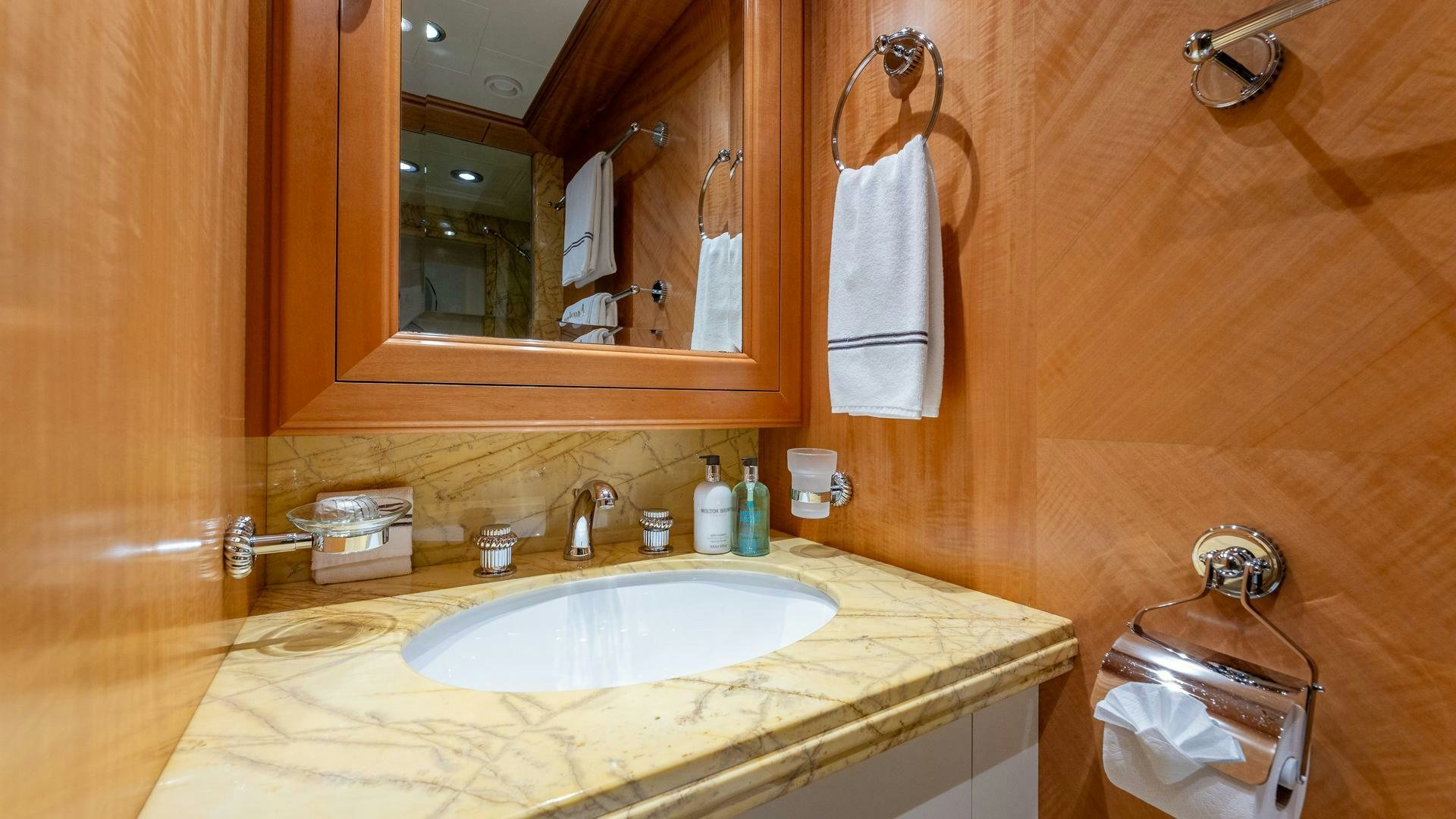 a bathroom with a sink and mirror aboard AMANTI Yacht for Sale