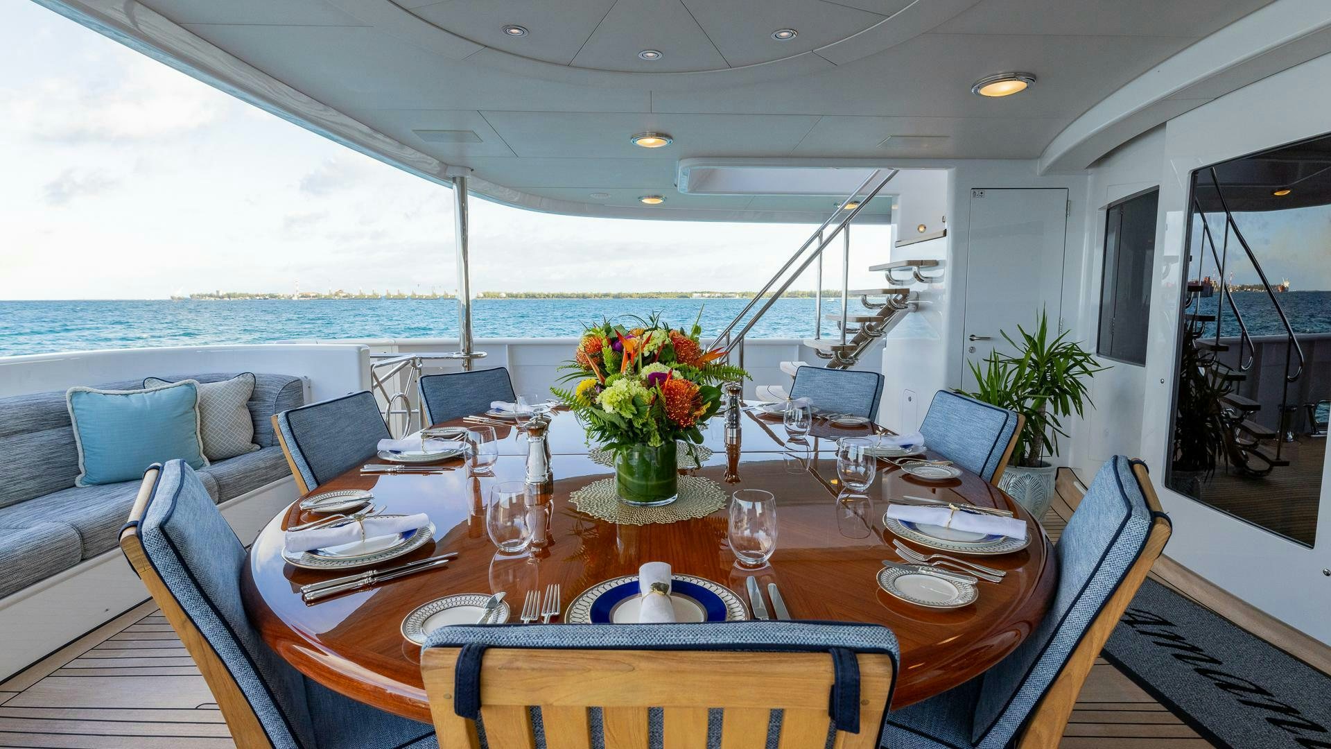 a dining table with chairs and a plant on it aboard AMANTI Yacht for Sale